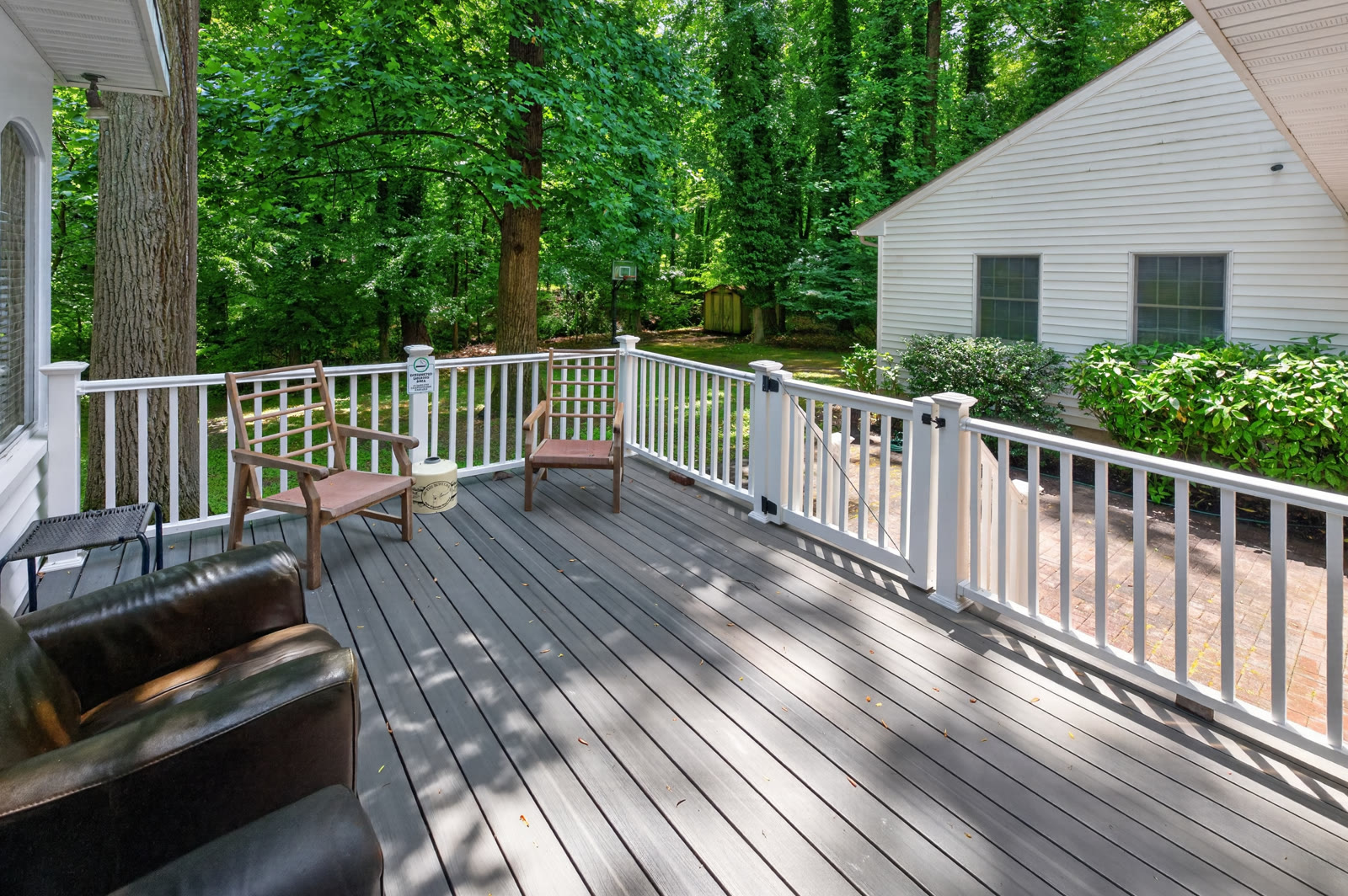 Back deck with seating under the trees