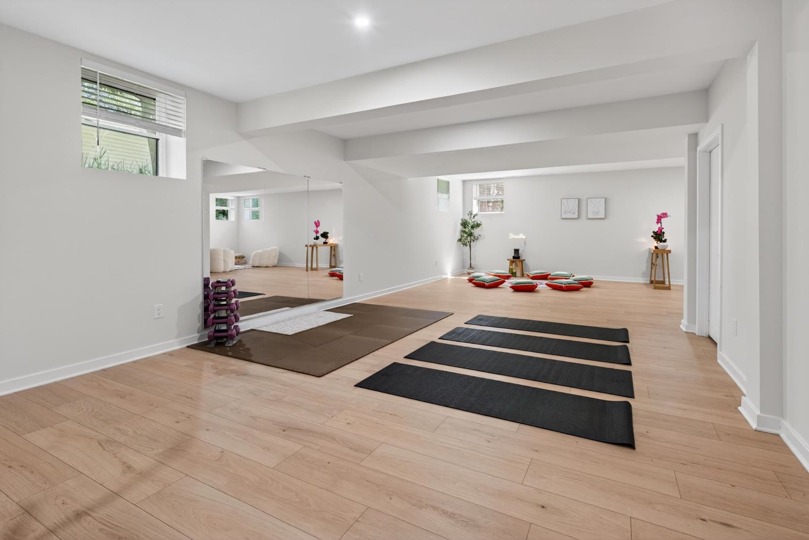 Home gym and yoga space with mats and mirrors